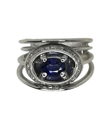 White gold ring with blue sapphire in diamond halo
